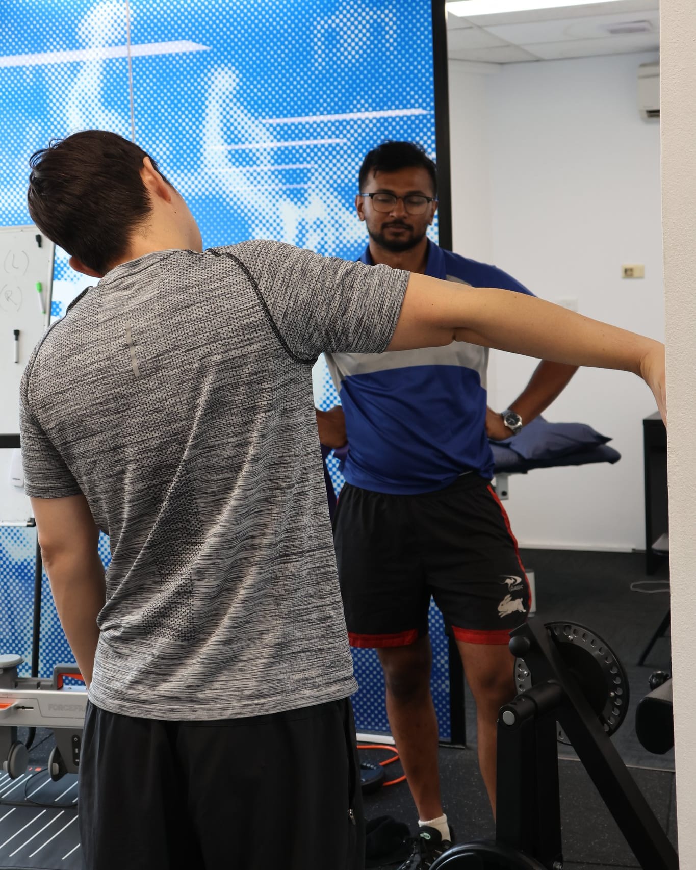 Shoulder range of movement assessment against the wall with a VALD ForceFrame in shot at SportsFit Five Dock