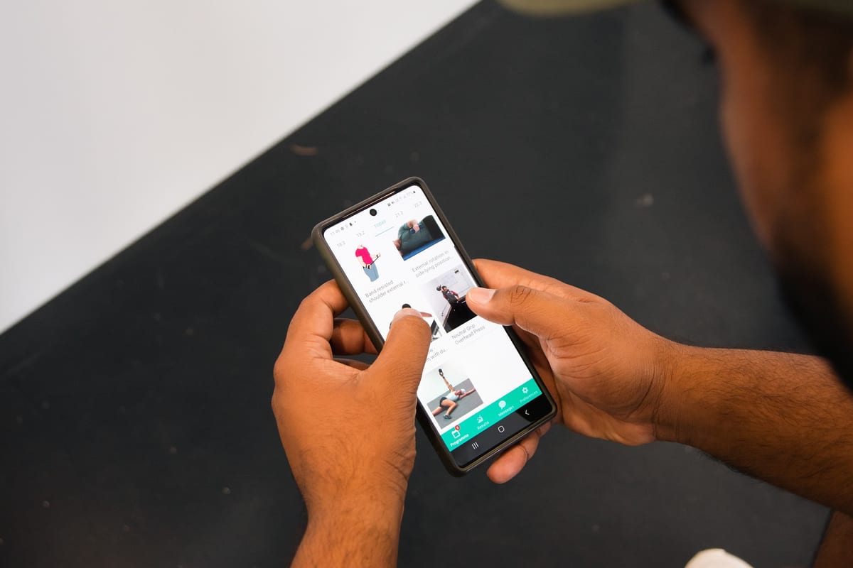 Patient reading their shoulder exercise program on the SportsFit app